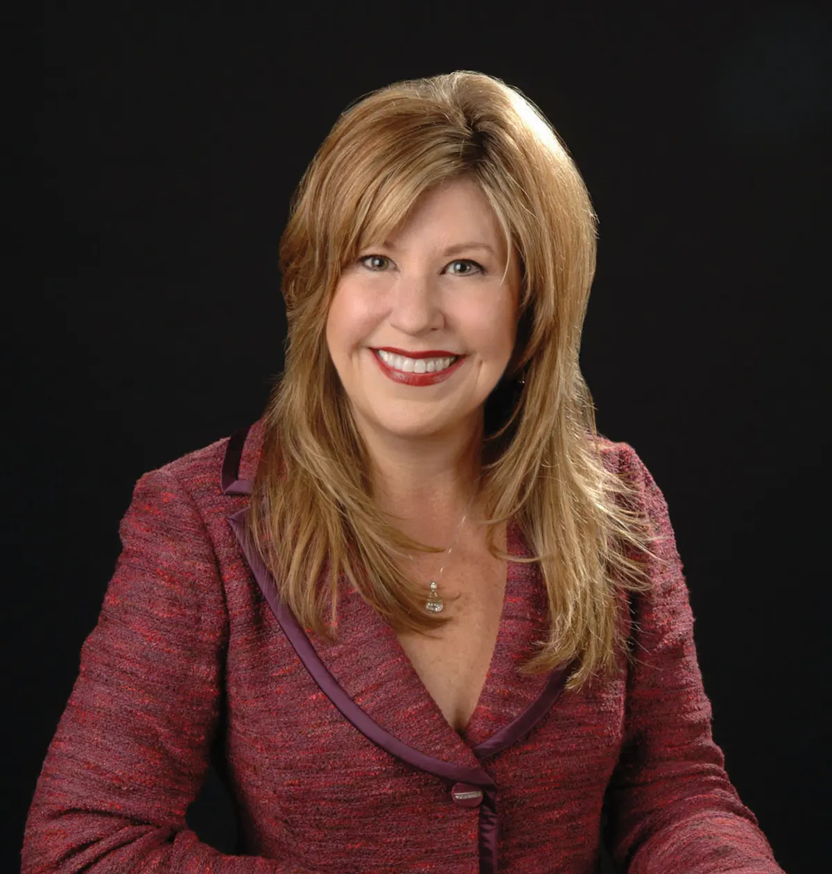 A woman in a red jacket and black shirt, Pamela Chambers O’Rourke, Founder and CEO of Icon Consultant and Vendorpass.